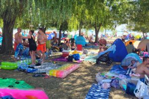 lidé relaxující na pláži Lidó Strand III ve městě Vonyarcvashegy, Balaton, Maďarsko